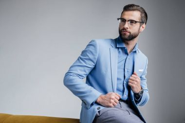 stylish handsome man in eyeglasses and blue trendy suit