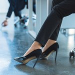 Cropped image of businesswoman sitting on chair in office