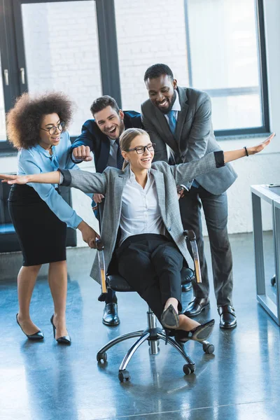 Multicultural Businesspeople Having Fun Racing Colleague Chair Workspace — Stock Photo, Image