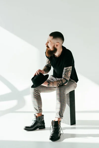 Stylish Tattooed Man Sitting Holding Hat White — Stock Photo, Image