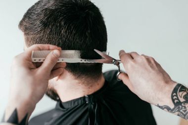 beyaz izole berber, makas ve tarak ile müşteri saç kesme berberin kırpılmış görüntü
