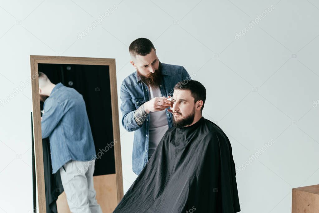 barber shaving client hair at barbershop isolated on white