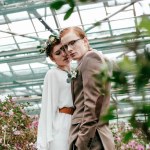 Portrait of stylish bride and groom in greenhouse