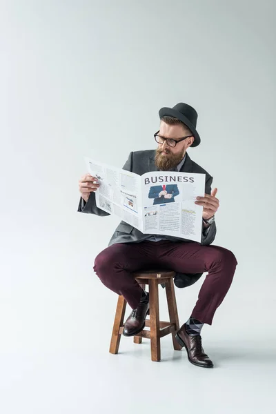 Stylish Bearded Businessman Reading Business Newspaper While Sitting Stool — Free Stock Photo