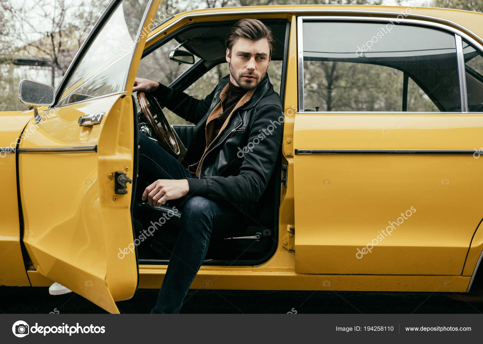Handsome Stylish Young Man Leather Jacket Sitting Yellow Classic Car Handsome Stylish Young Man Leather Jacket Sitting Yellow Classic Car Stock Photo