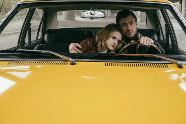 Handsome Young Man Driving Car Embracing Beautiful Pensive Girlfriend — Stock Photo, Image