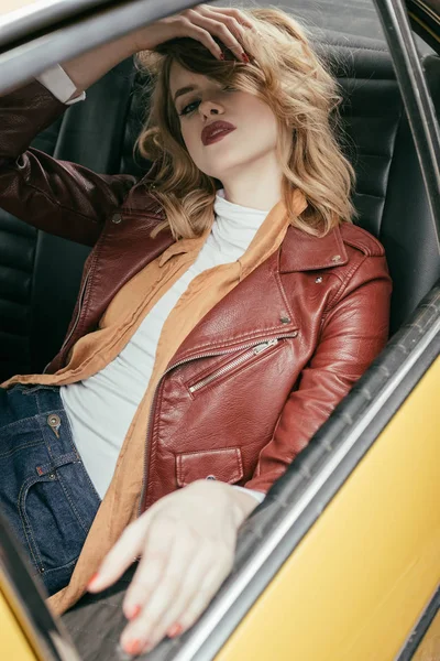 Seductive Girl Leather Jacket Sitting Classic Car Looking Camera — Free Stock Photo