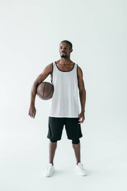 spor giyim üzerine beyaz izole basketbol topuyla yakışıklı Afrikalı-Amerikalı adam