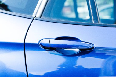 Close-up view of handle in blue car door  clipart