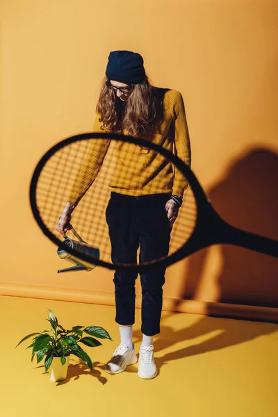 Stylish Man Watering Plant View Tennis Racket Yellow — Free Stock Photo