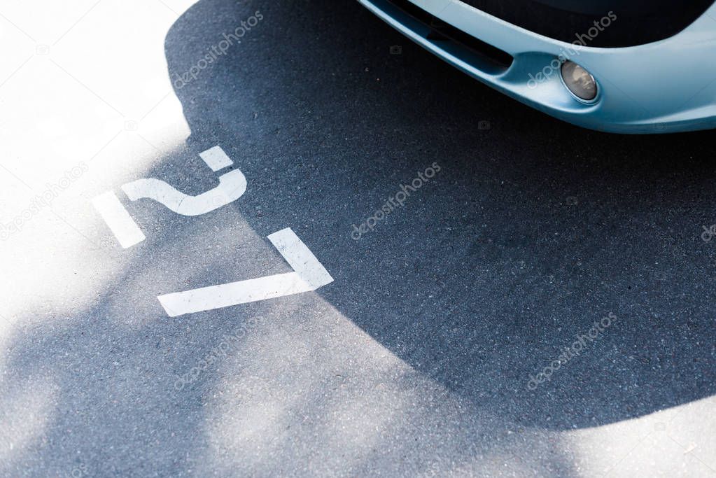 Close-up view of car on street parking lot at number 27