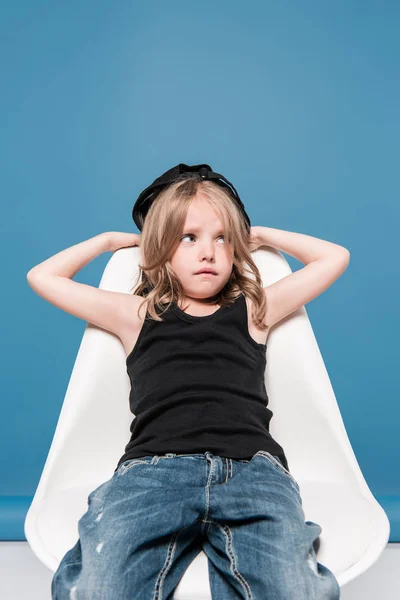 Stylish kid girl sitting on chair — Stock Photo