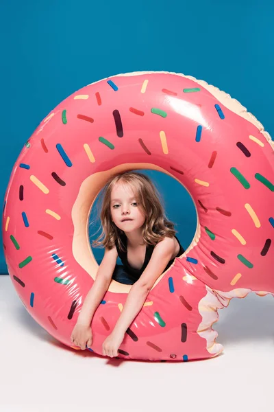 Little girl sitting at swimming tube — Stock Photo