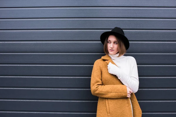 Femme élégante en veste et chapeau noir — Photo de stock