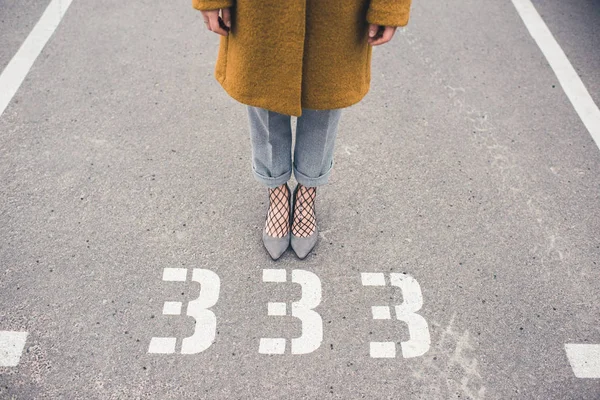 Woman in stylish shoes standing on road — Stock Photo