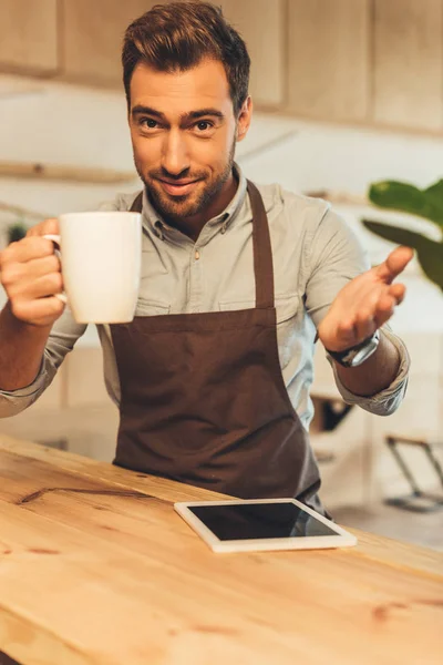 Barista with cup of coffee — Stock Photo