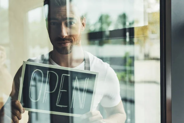 Waiter holding chalkboard with open word — Stock Photo