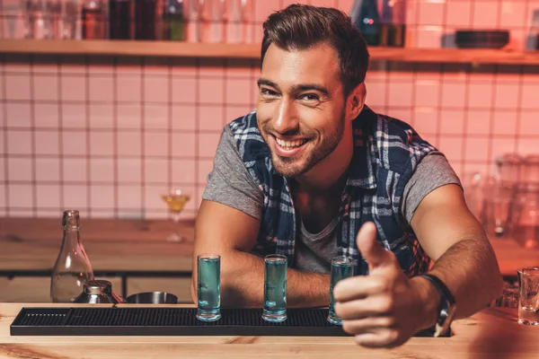 Barman showing thumb up at counter — Stock Photo