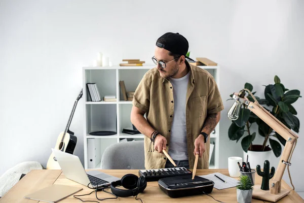 Sound producer playing on drum machine — Stock Photo