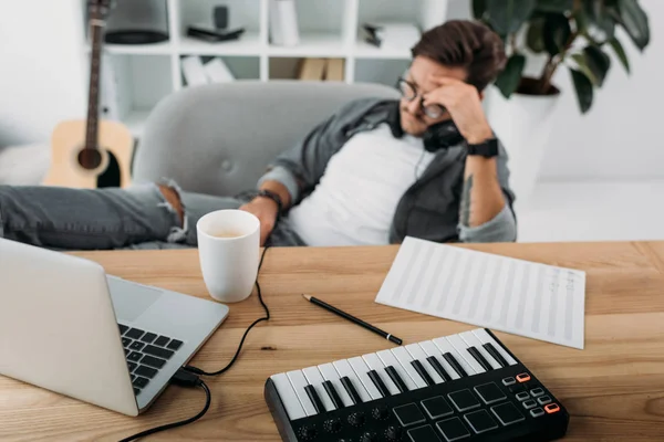 Musician sitting in armchair — Stock Photo