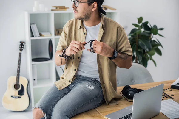 Man sitting on worktable — Stock Photo