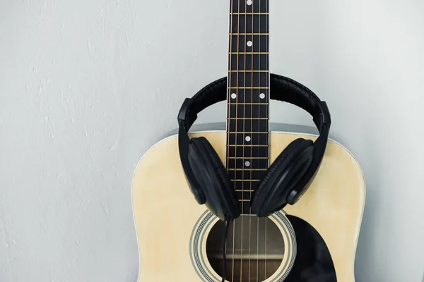 Acoustic guitar and headphones — Stock Photo