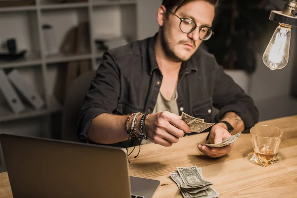 Handsome man counting cash — Stock Photo