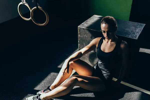 Athletic sportswoman resting at gym — Stock Photo