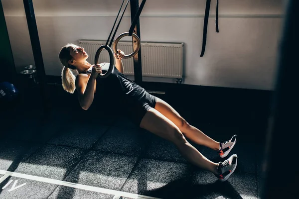 Sportswoman on gymnastic rings — Stock Photo