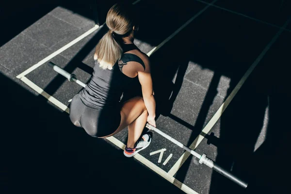 Sportswoman lifting barbell — Stock Photo