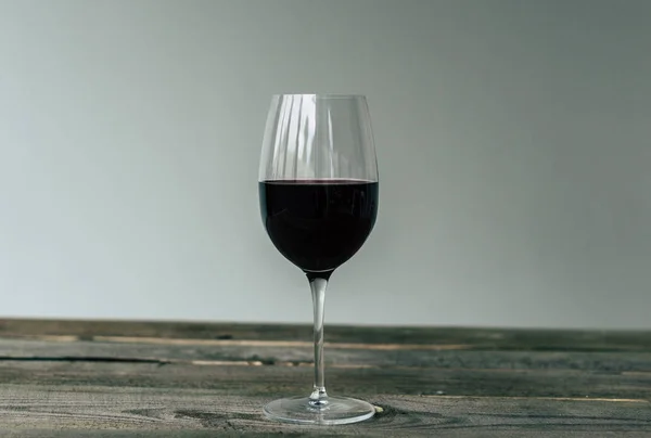 Glass of red wine on table — Stock Photo