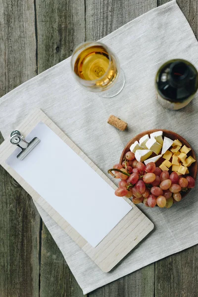 Glass with wine and clipboard — Stock Photo