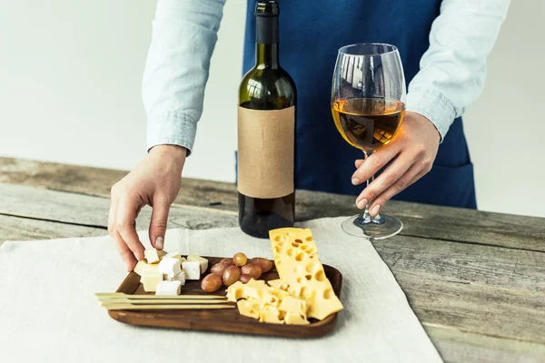 Sommelier taking glass of wine and cheese — Stock Photo