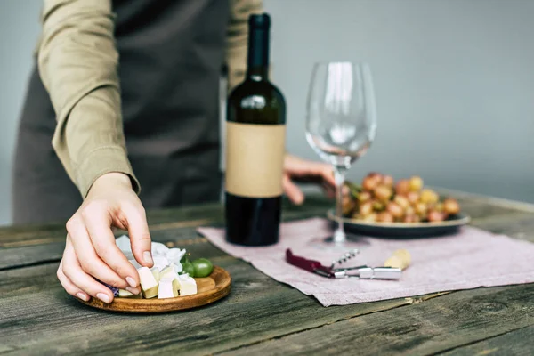 Taster taking piece of brie cheese — Stock Photo