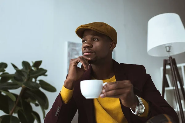 Thoughtful african american businessman with coffee — Stock Photo