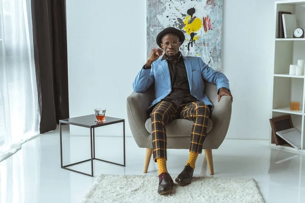 Fashionable man sitting in armchair — Stock Photo