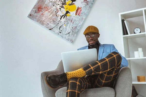 Businessman using laptop in office — Stock Photo