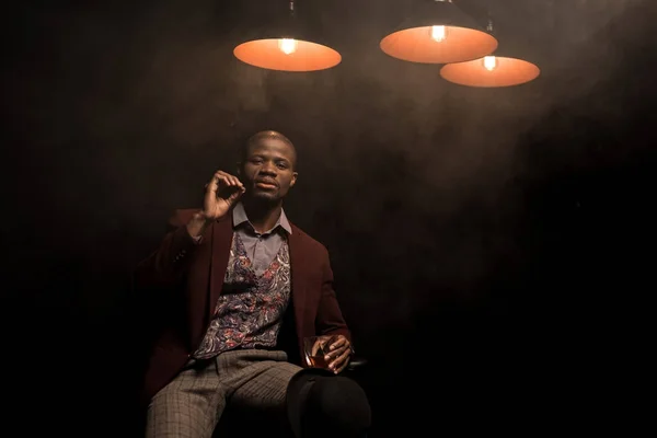 Man with cognac smoking cigar — Stock Photo