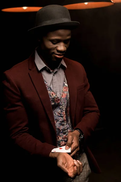 African american man with ace in sleeve — Stock Photo