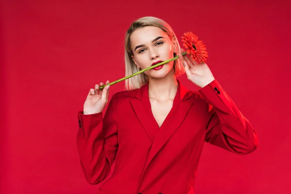 Girl with flower in mouth — Stock Photo