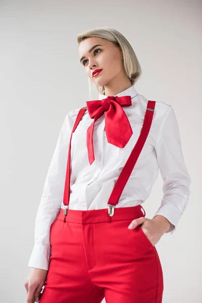 Fashionable girl in red suspenders and bow — Stock Photo