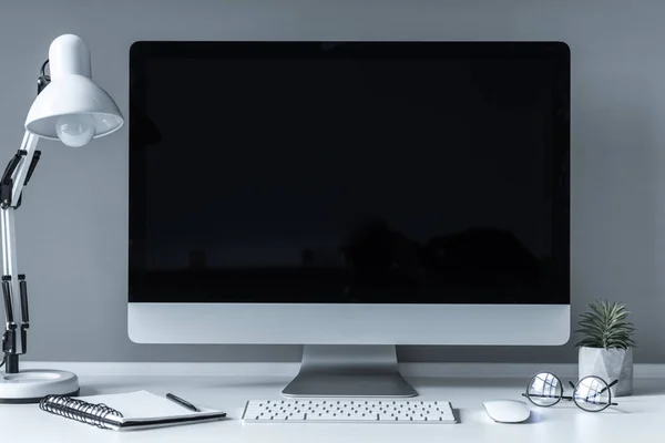 Working place with table lamp and plant — Stock Photo