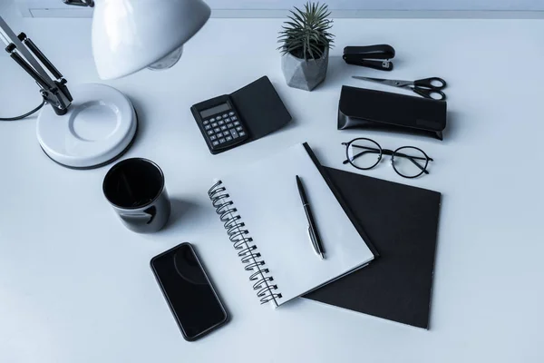 Overhead view of notebook and pen on working table — Stock Photo