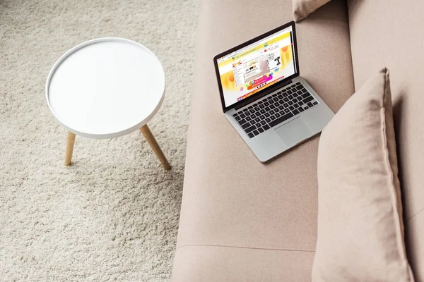 High angle view of laptop standing on cozy couch with aliexpress website on screen — Stock Photo