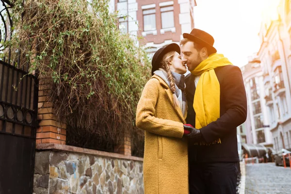 Beautiful young couple hugging and kissing at street — Stock Photo