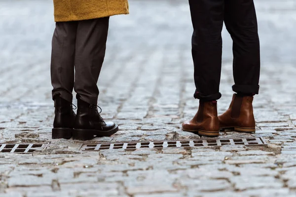 Cropped image of female and male legs in autumn shoes — Stock Photo