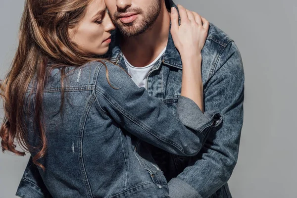 Обрізаний знімок спокусливої молодої пари, обіймаючись ізольовано на сірому — стокове фото