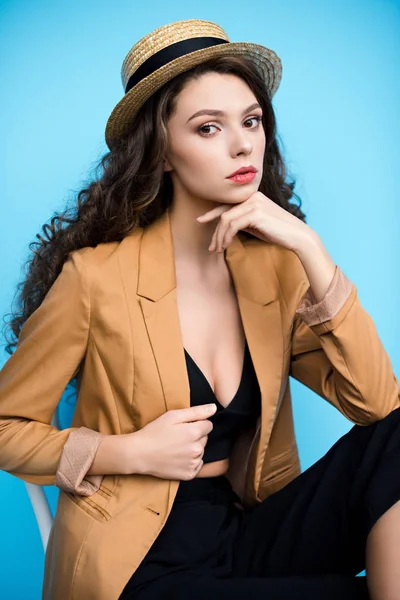 Attractive young woman in canotier hat and stylish jacket looking at camera — Stock Photo