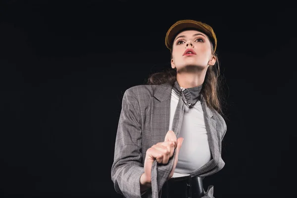 Beautiful woman in elegant stylish jacket posing isolated on black — Stock Photo