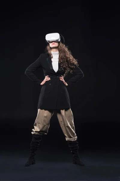 Full length view of stylish young woman using virtual reality headset on black — Stock Photo